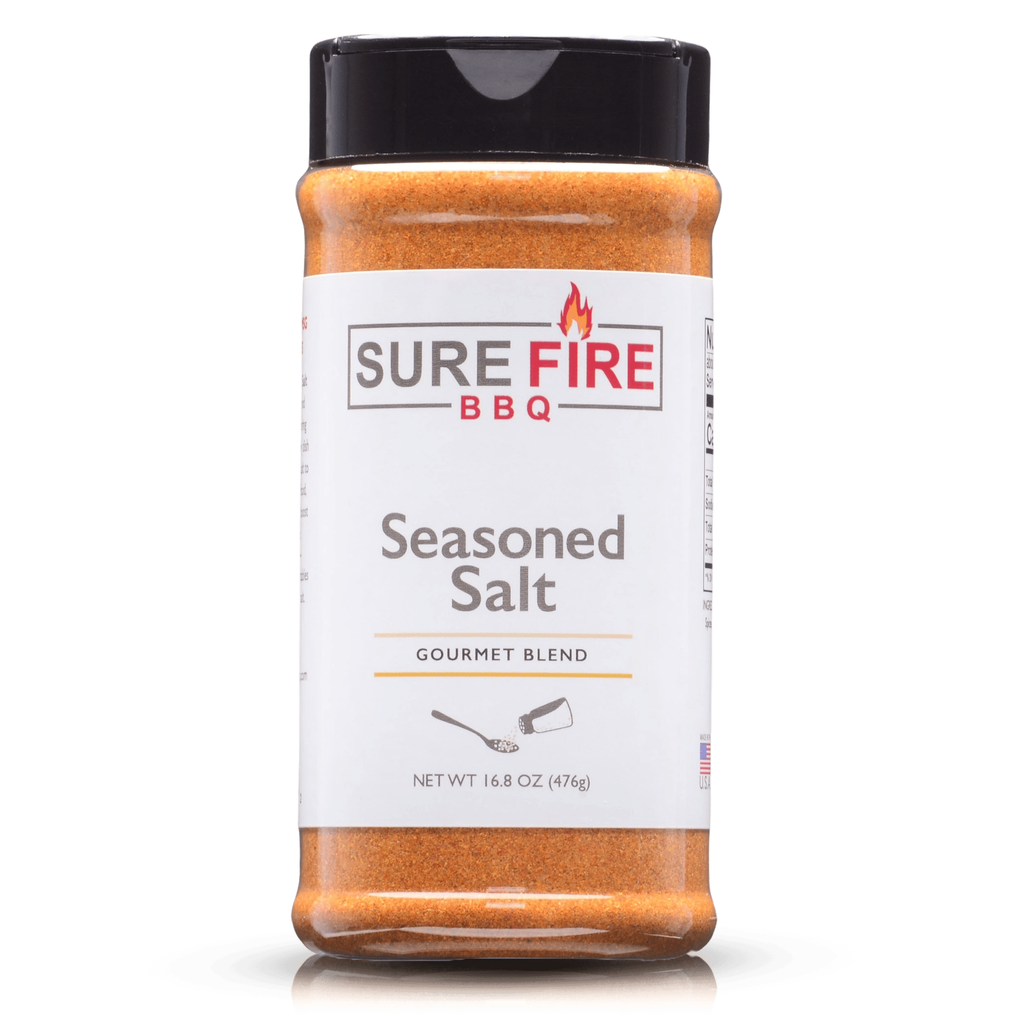 A bottle of Sure Fire BBQ Seasoned Salt, Gourmet Blend, 16.8 oz, featuring a black cap and a white label with red and gray text, designed to enhance the flavor of meats, seafood, and vegetables.