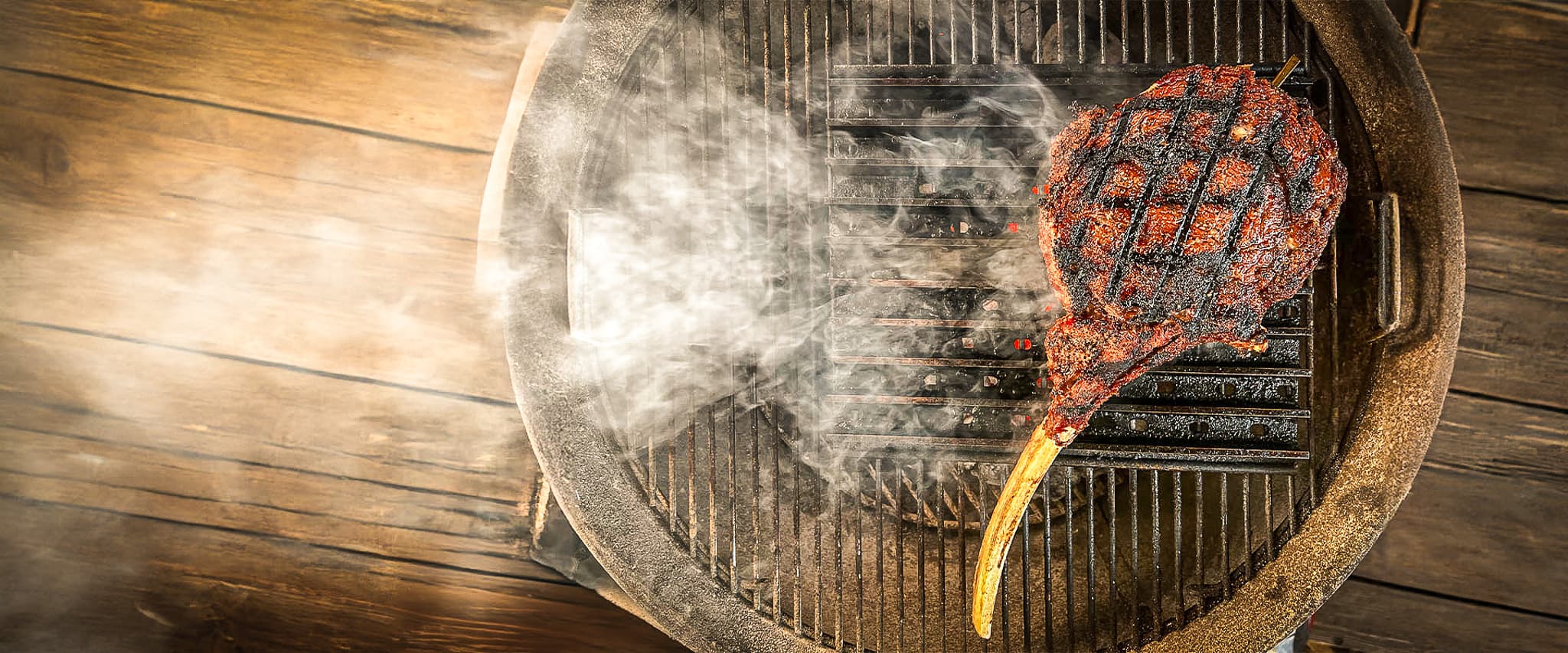 Tomahawk ribeye steak searing on grill