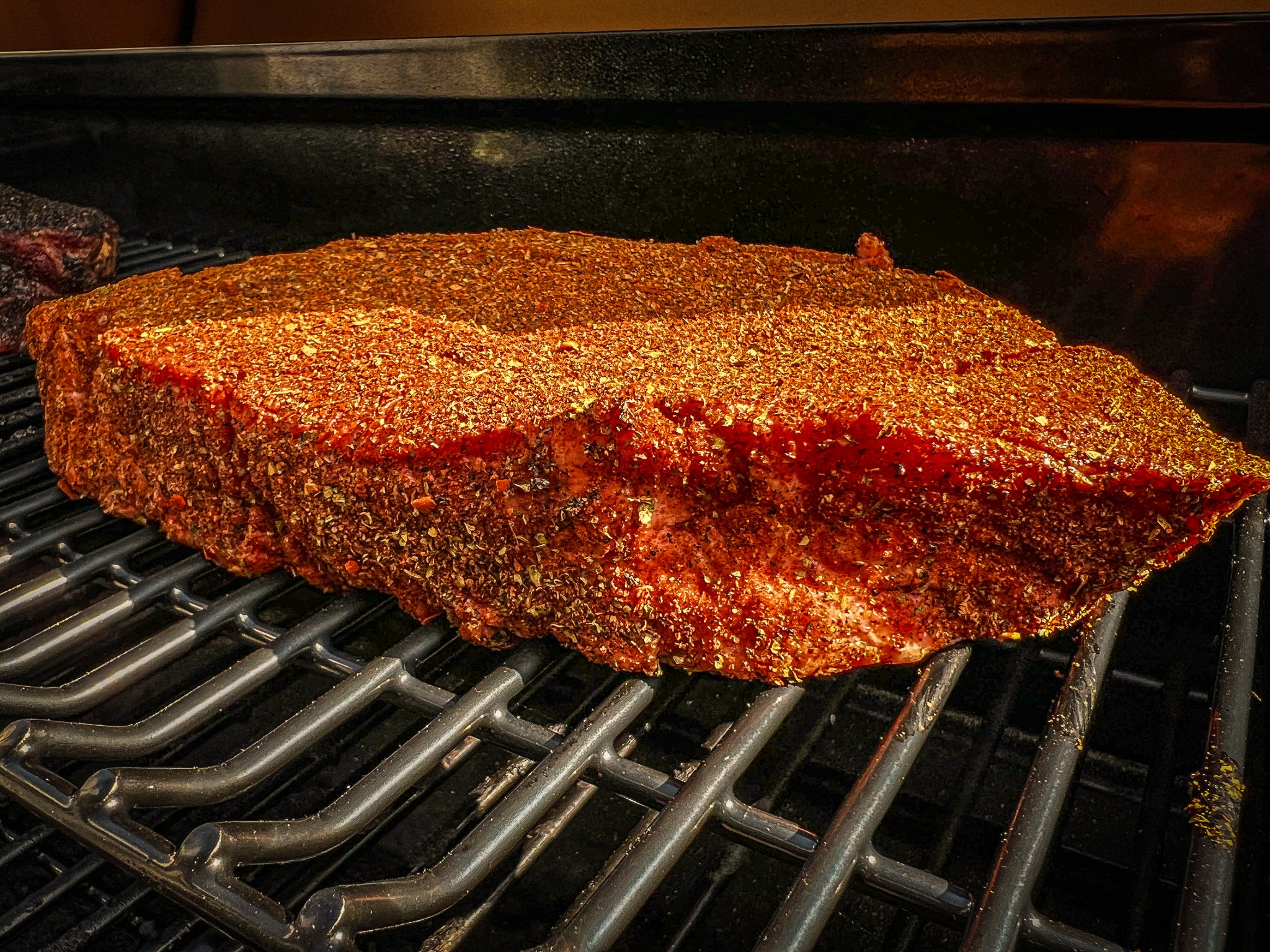 Beef chuck roast seasoned with Smoked Taco Seasoning and placed on pellet smoker to cook