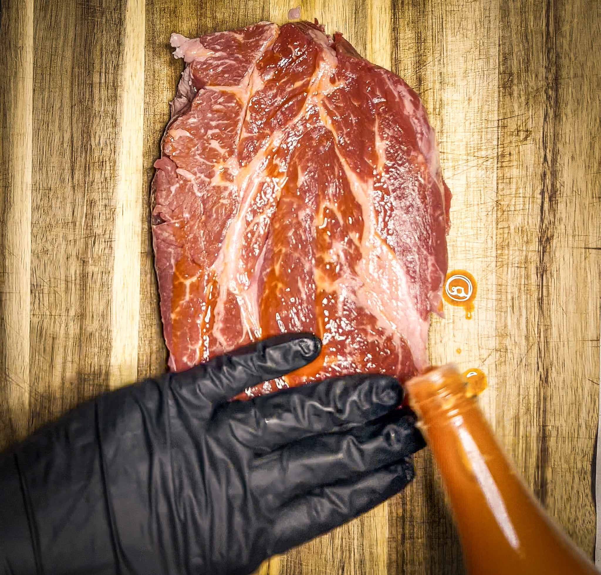 Beef chuck roast slathered with hot sauce as a binder for the Smoked Taco Seasoning