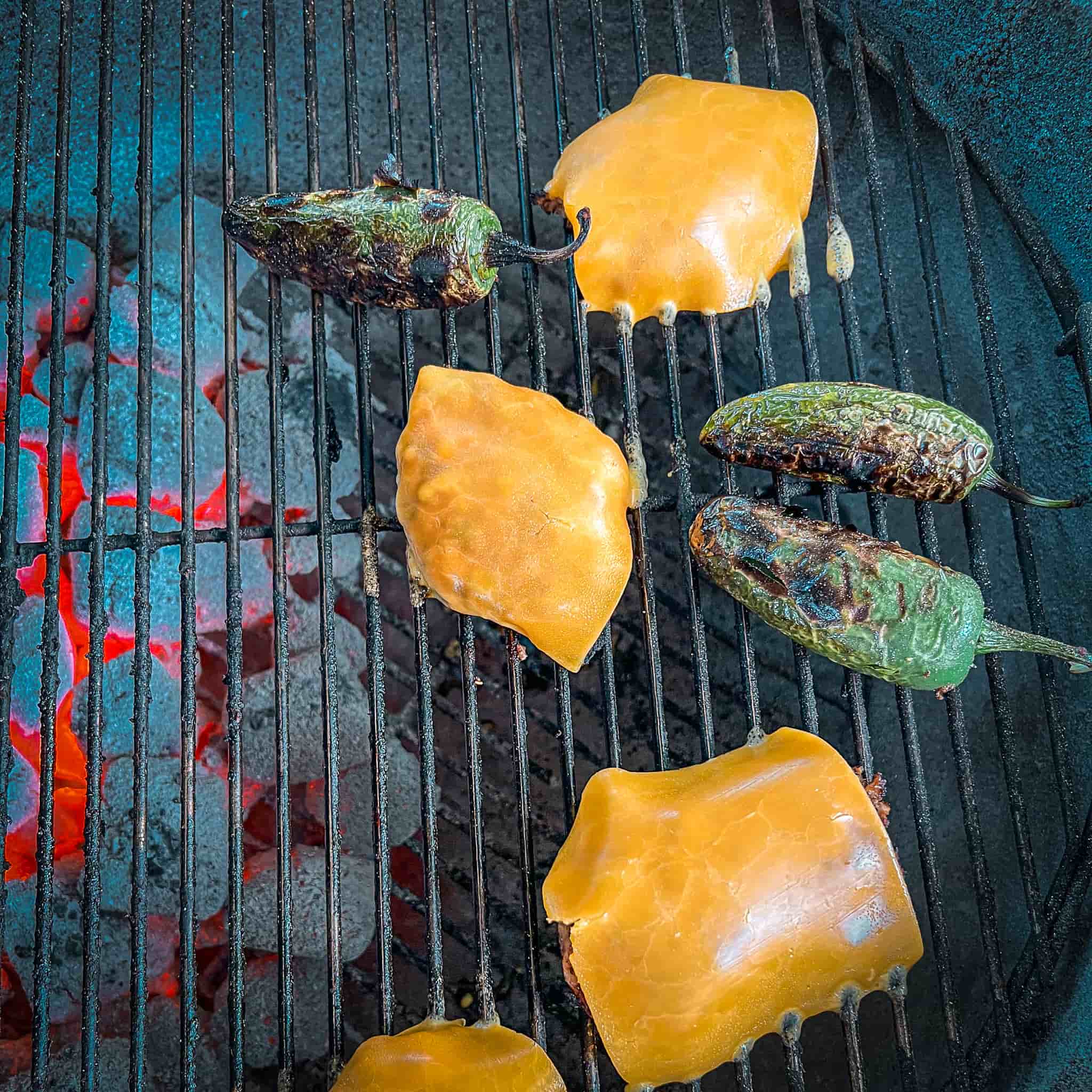 Grilled chicken thighs covered with sharp cheddar cheese