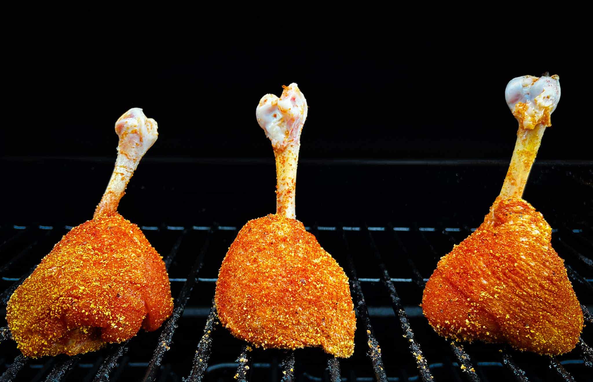 Lollipop drumsticks upright on grill