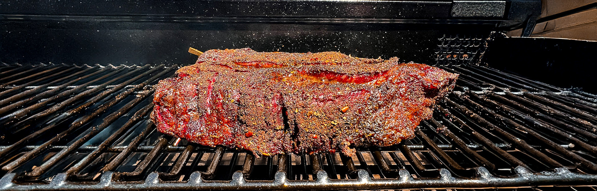 Beef chuck roast seasoned with Sure Fire BBQ Smoked Taco Seasoning on pellet smoker