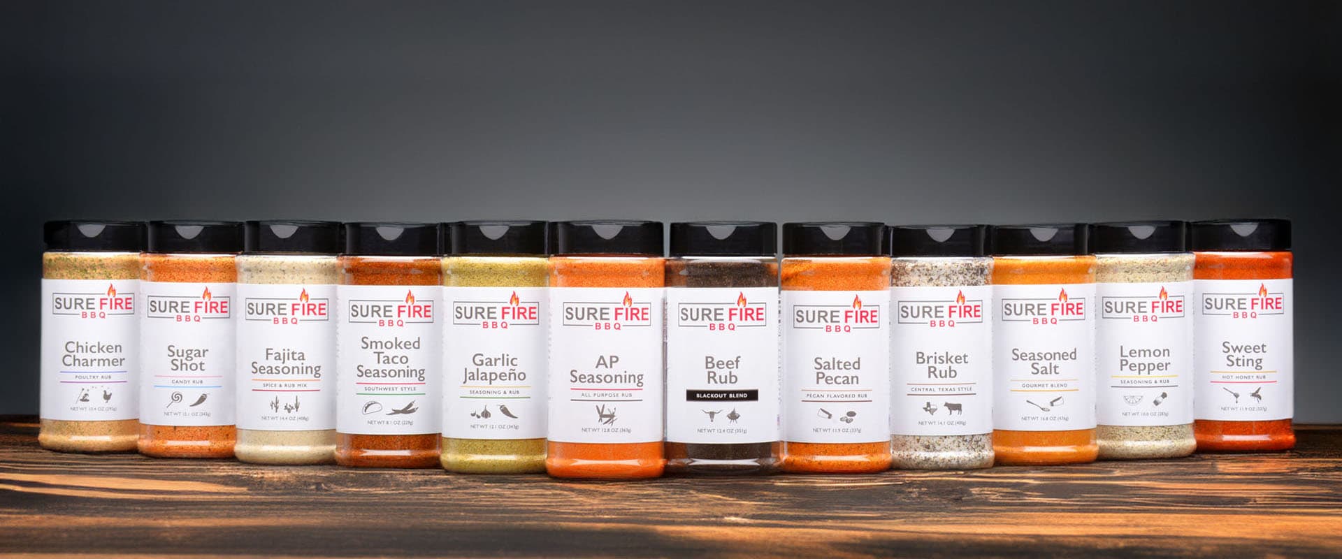 Collection of Sure Fire BBQ's twelve premium rubs and seasoning.